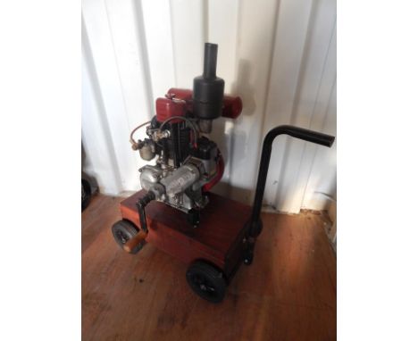 An early 20thC Lyon Norman type 56 stationary engine, with articulated side handle, black funnel and partially painted fuel r