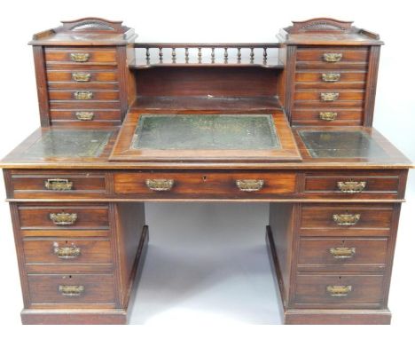 A Victorian mahogany twin pedestal desk, with a central shelf above a writing slope enclosing drawers and recesses, flanked b