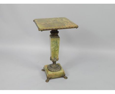 A French late 19thC onyx champleve enamel and ormolu mounted side table, the square screw top raised on a fluted and gadroone