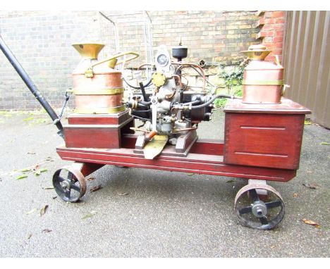 A stationary engine, centred by a WMA627 board engine with articulated parts, flanked by two sized Chekpump brass and copper 