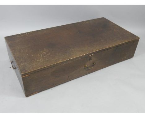 A stained pine trunk, early 20thC, with brass handles, raised on castors, 119cm x 58cm x 26cm.