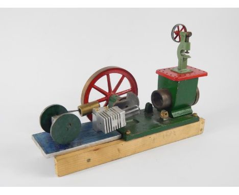 A part scratch built stationary engine, with pierced cog, 13cm diameter flywheel, partially made, together with a separate pa