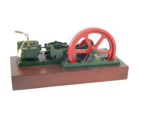 A live steam partial horsepower table top stationary engine, in red and green with 17cm dia. pierced drive wheel attached to 