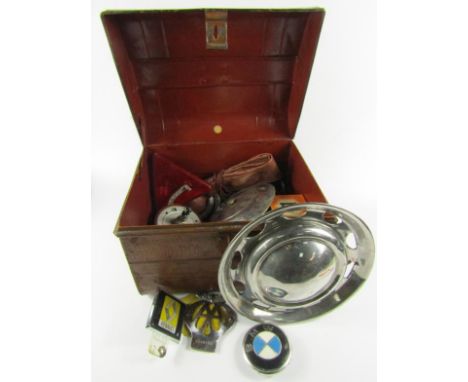 AA and other car badges, hub caps, lamps, filters, name plates and sundry automobilia in a tin trunk.