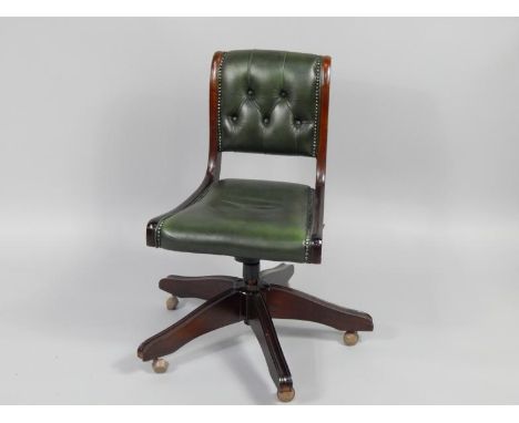 A mahogany and button upholstered green leather office swivel chair.