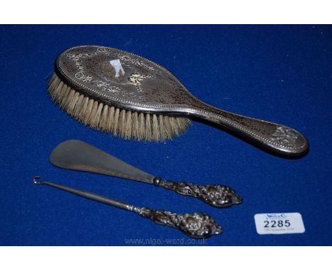 A silver backed Mirror, Shoe Horn and Button hook.