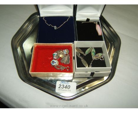 Four pieces of sterling Silver Jewellery including a bracelet with Mother of Pearl links, enamel bracelet with pendants, silv