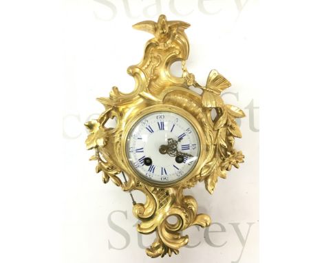 A 19th century French Ormolu cased wall clock by Japy Freres decorated with flowers, leaves a butterfly and bird surmount wit