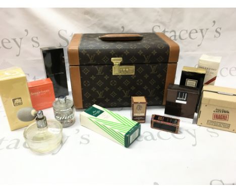 A replica Louie Vuitton case with boxed perfumes including Coco Chanel, Jean Paul, Cartier etc