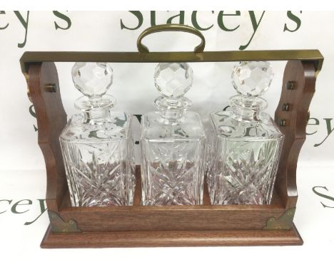 A reproduction three bottle tantalus. Shipping category D.