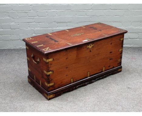 A 19th century Anglo Indian brass bound rectangular trunk, on shaped plinth, 96cm wide x 47cm high.