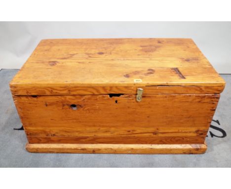 A pine rectangular lift top trunk on plinth base, 90cm wide x 43cm high.   E1