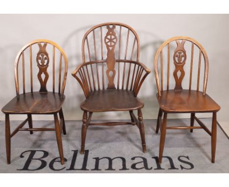 A set of six 20th century Ercol stianed beech stick back dining chairs, 40cm wide x 83cm high and a similar wheelback open ar