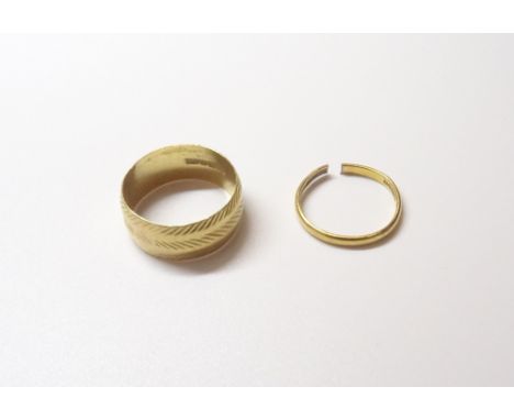 A 22ct gold wide band wedding ring, with faceted decoration, London 1969, ring size T and a 22ct gold plain wedding ring (cut