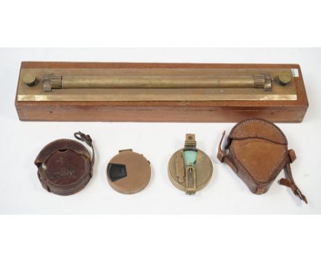A brass rolling rule by W.H. Harling, London in a mahogany case, 46.5cm wide, a Short & Mason brass pocket clinometer and ano
