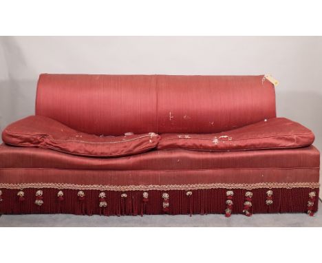 A 20th century hardwood framed red upholstered sofa with gold and red tasseled frieze, 200cm wide x 76cm high.  6309  C3