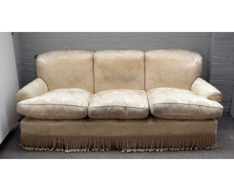 Peter Dugden; a three seat sofa with floral ivory embossed upholstery and tasselled frieze, 225cm wide x 92cm high. 