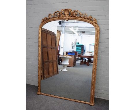 A Victorian gilt framed arch top overmantel mirror, with shell and acanthus scroll crest, 122cm x 173cm high.