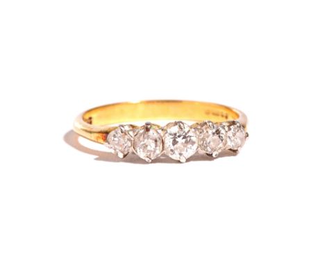 An 18ct gold and diamond set five stone ring, claw set with a row of cushion shaped diamonds graduating in size to the centre