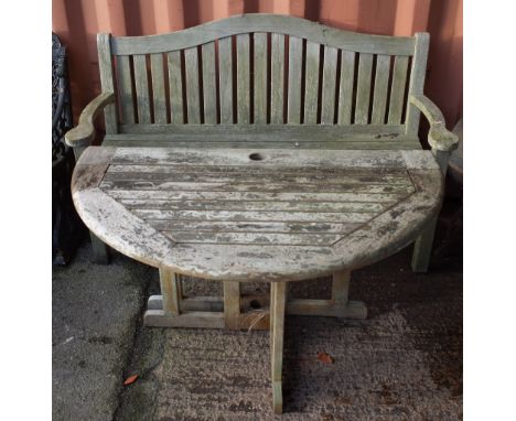 Garden furniture; a teak arched back garden bench, 154cm wide x 100cm high and a drop flap circular table, 120cm diamerte x 8