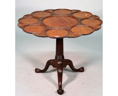 An 18th century mahogany supper table, the snap top with nine dished recess divided by scallops, the tripod base with reeded 