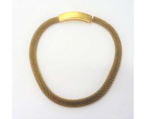 A gold collar necklace, in an interwoven mesh link design, the curved clasp of panel form, having textured decoration, detail
