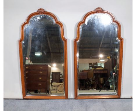 A pair of 20th century mahogany framed arch top wall mirrors, with bevelled glass, 45cm wide x 86cm high, (2).