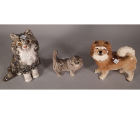 A 20th century glazed ceramic model of a cat, 24cm high, a smaller Doulton cat, 13cm high and a ceramic dog, 19cm high, (3). 