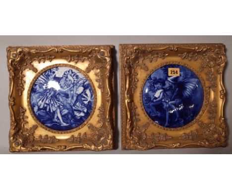 A pair of blue and white ceramic panels, depicting flower faries, each panel 17cm diameter.   ROST