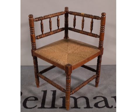A 19th century stained beech bobbin turned corner chair, 61cm wide x 70cm high.  A2