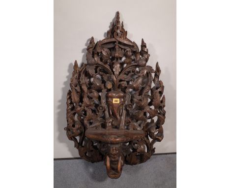 A 20th century carved hardwood hanging shelf, 50cm wide x 75cm high. 