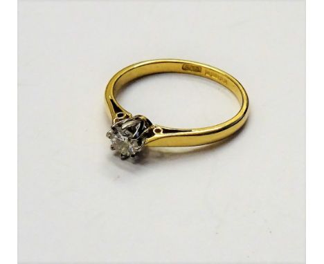 An 18ct gold and diamond single stone ring, claw set with a circular cut diamond, detailed 021, ring size L and a half.