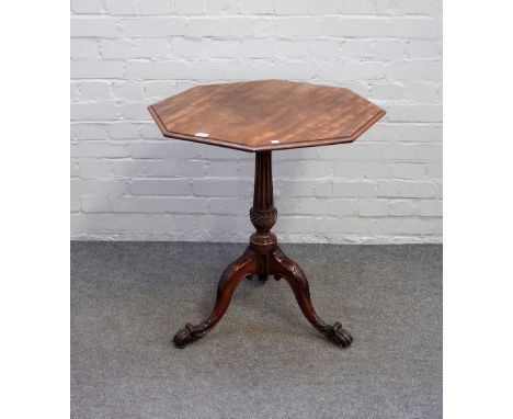 A George III and later mahogany occasional table, the octagonal oval snap top on fluted column and carved tripod base, 65cm w