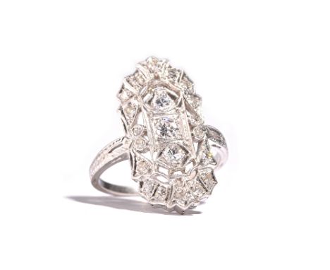 A platinum and diamond set ring, of pierced panel shaped form, mounted with circular cut diamonds, between floral engraved sh