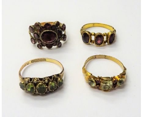 An early 19th century gold ring, mounted with foil backed flat cut garnets, between split shoulders, a Victorian gold, chryso