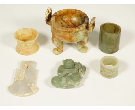 A group of Chinese jades, various colours, comprising; an archaistic axe pendant, 9cm. high; a small tripod censer, 8cm. high