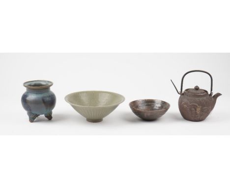 A group of Chinese ceramics, comprising; a celadon bowl incised with flowers beneath an overlapping stiff leaf border, 20.5cm