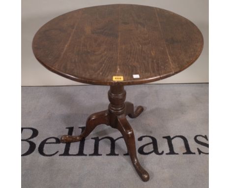 An 18th century oak circular snap top tripod occasional table, diameter 73cm, 69cm high. 