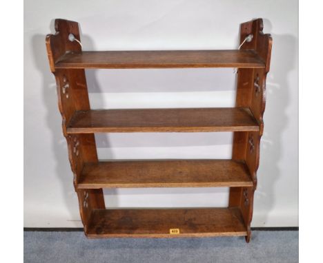 An early 20th century oak four tier hanging shelf, 56cm wide x 72cm high. 