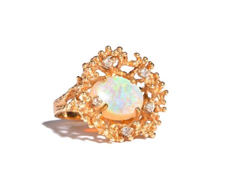 A gold, opal and diamond ring, claw set with the oval opal at the centre, in a surround of five circular cut diamonds, the mo