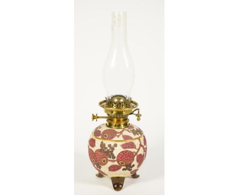 A Hinks No 2 pottery oil lamp circa 1886, the circular foliate painted body raised on three shaped feet with brass Hinks burn