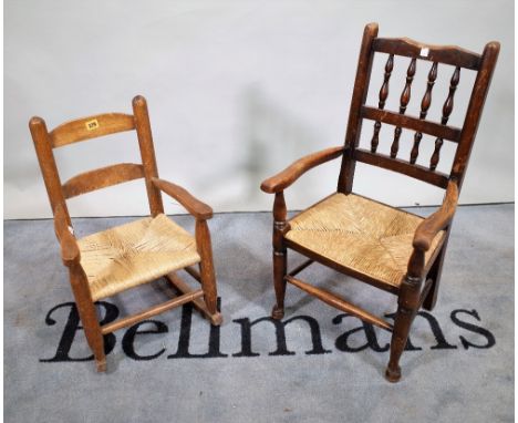 An 18th century style child's Lancashire bobbin back open armchair, with rush seat, on turned supports, 43cm wide x 77cm high