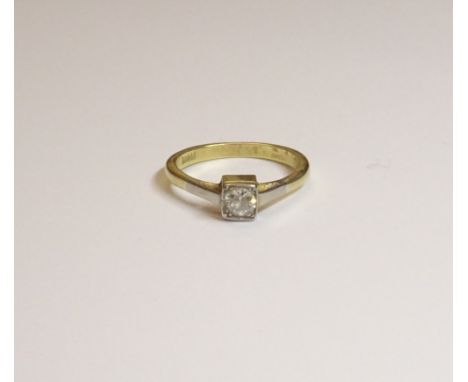 A gold and diamond single stone ring, mounted with a cushion shaped diamond within a square shaped setting, detailed 18 CT, r