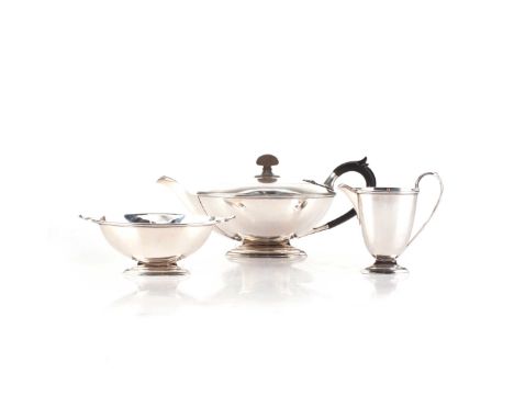 Comprising: a tea pot, milk jug and sugar bowl, each with reeded border, the teapot with ebonised leaf-capped handle, the hin