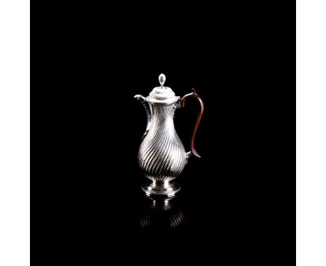 Baluster-shaped, the hinged cover with bud finial, beaded rim, wooden leaf-capped handle, the body with spiral gadrooned deco