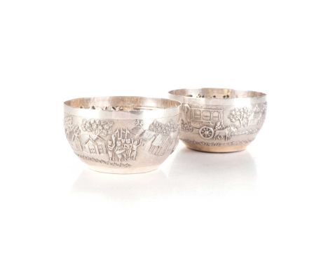 Each deep rounded bowl embossed with a village narrative illustrating figures at various pursuits within architectural landsc