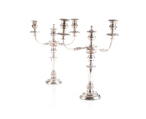 Each tapering stem with a baluster-shaped sconce, the detachable three-light fitting with reeded arms, on a stepped circular 