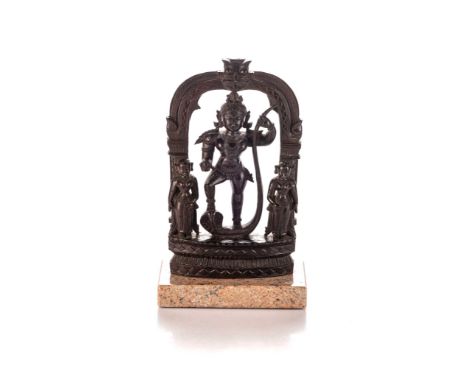 The bejewelled figure standing with his right foot raised astride a cobra beneath an architectural arch flanked by two attend