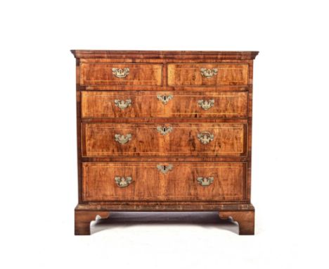 The rectangular cross banded top above a pair of short drawers, three long graduating drawers below, on bracket feet, stringi