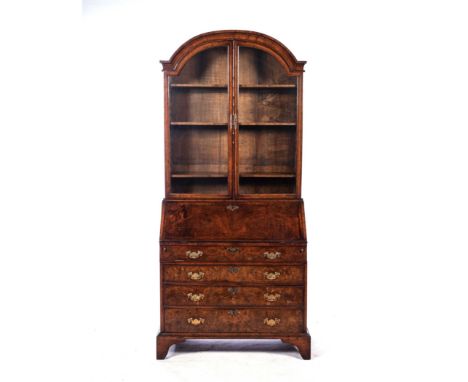 In two parts, the gabled pediment above a pair of glazed doors enclosing two asdjustable shelves, the lower section comprisin